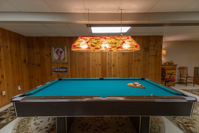 recreation room featuring a drop ceiling, pool table, and wood walls