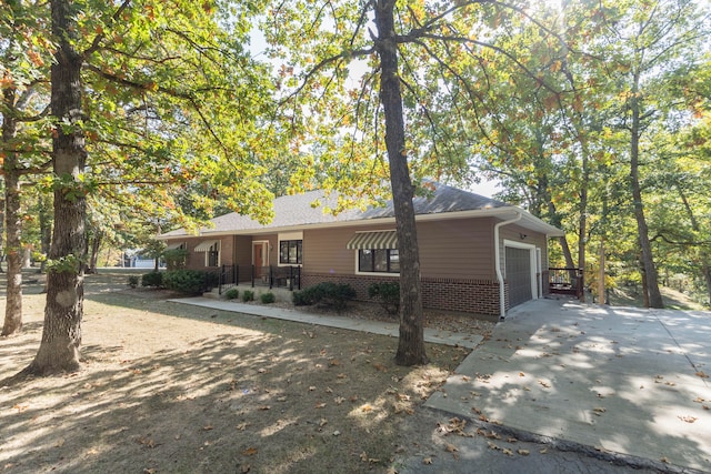 single story home featuring covered porch and a garage