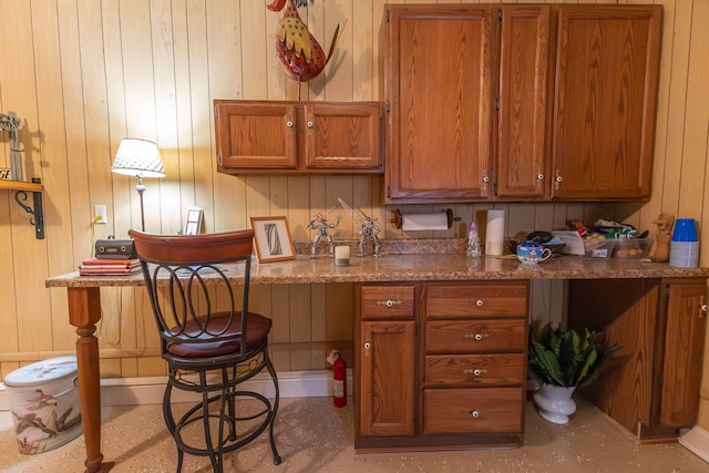 kitchen featuring wood walls and a kitchen breakfast bar