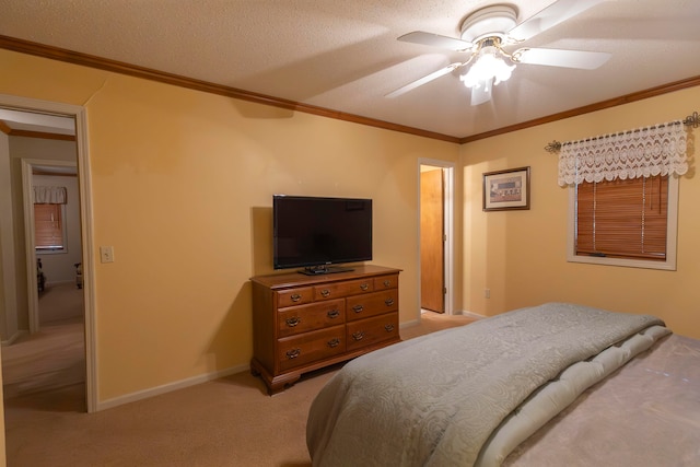 bedroom with a textured ceiling, ceiling fan, ornamental molding, and light colored carpet