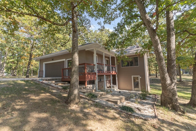 view of front of house with a garage and a wooden deck