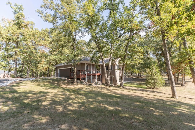 view of yard featuring a deck and a garage