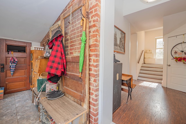 mudroom with wood-type flooring and lofted ceiling