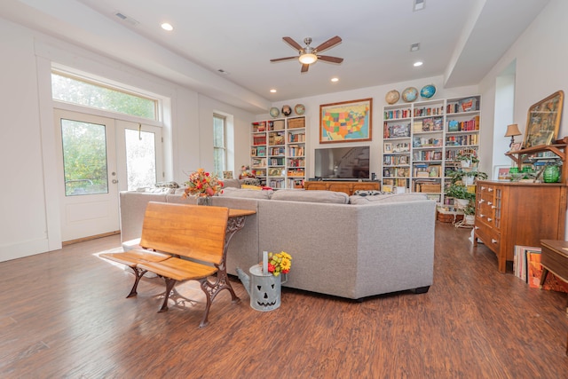 living room with ceiling fan, dark hardwood / wood-style floors, french doors, and built in shelves