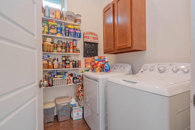 clothes washing area featuring washer and clothes dryer, dark hardwood / wood-style floors, and cabinets