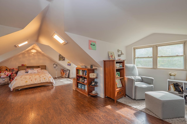 bedroom featuring hardwood / wood-style flooring and vaulted ceiling with skylight