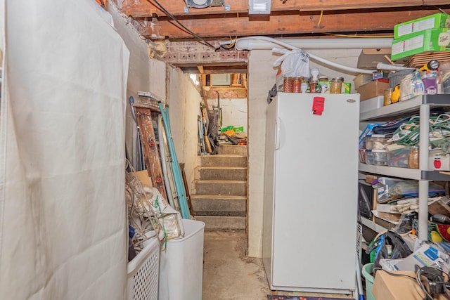 basement featuring white fridge