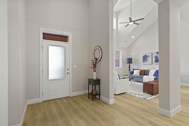 foyer featuring high vaulted ceiling, light wood-type flooring, and ceiling fan