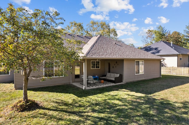 rear view of house featuring a patio area, a yard, and an outdoor living space