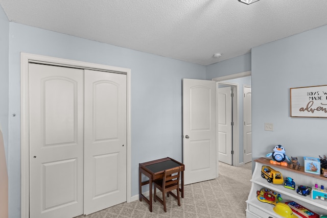 game room featuring light carpet and a textured ceiling