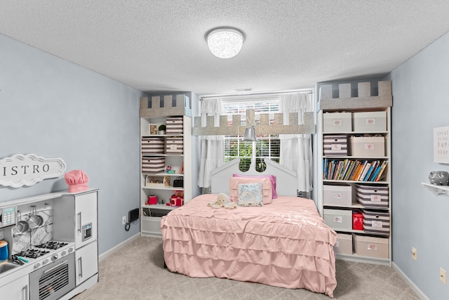 bedroom featuring light carpet and a textured ceiling