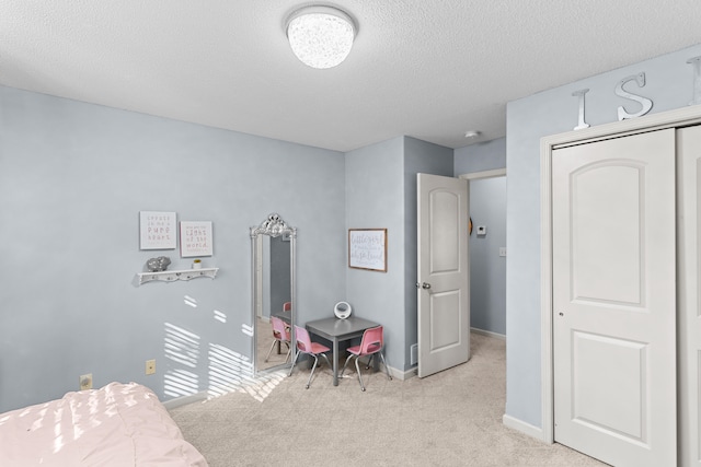 carpeted bedroom featuring a closet and a textured ceiling