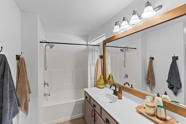 bathroom featuring vanity, tile patterned floors, shower / bath combo with shower curtain, and a textured ceiling