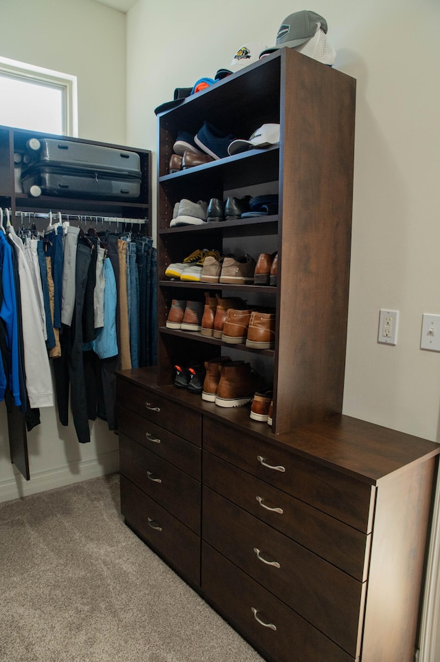 walk in closet featuring light carpet