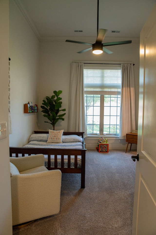 carpeted bedroom with ceiling fan and crown molding