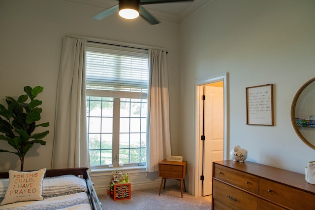 bedroom with ornamental molding, ceiling fan, multiple windows, and light colored carpet