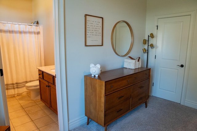 bathroom with vanity, toilet, and tile patterned floors