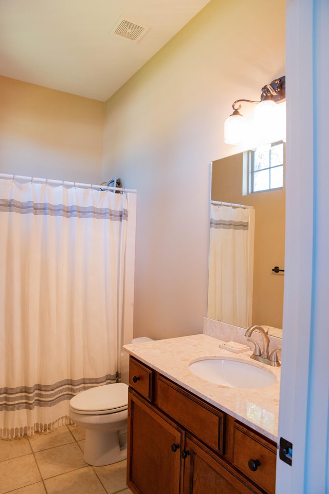 bathroom with vanity, a shower with shower curtain, toilet, and tile patterned floors