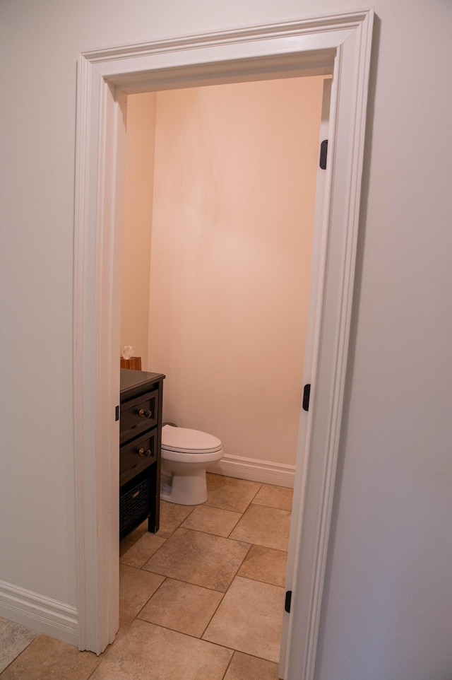 bathroom featuring vanity, toilet, and tile patterned flooring