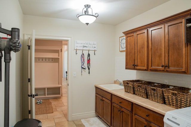 laundry room with washer / dryer, sink, and cabinets