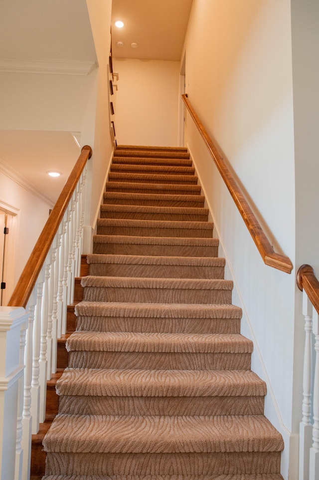 stairs featuring crown molding