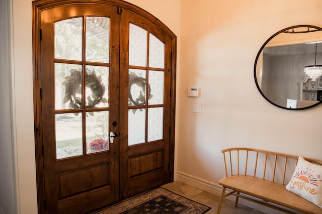 entryway with french doors, a healthy amount of sunlight, and tile patterned floors