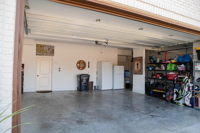 garage featuring a garage door opener and white refrigerator