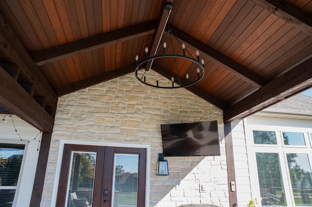 exterior details featuring a notable chandelier, beam ceiling, and wood ceiling