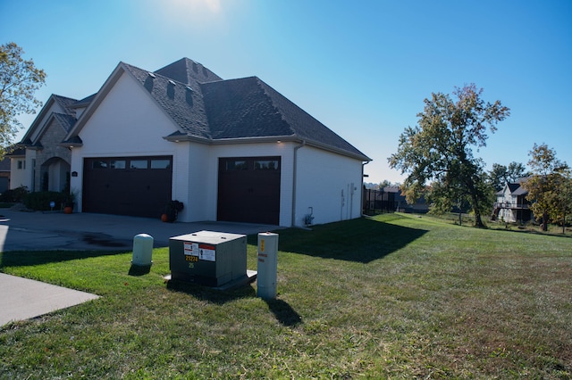 view of home's exterior with a lawn and a garage