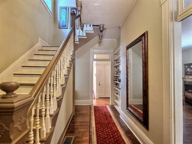 hall featuring ornamental molding and hardwood / wood-style floors