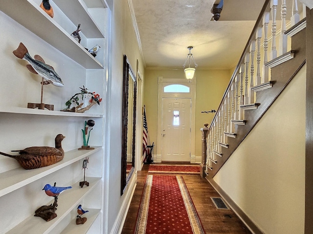 doorway featuring ornamental molding and dark hardwood / wood-style floors