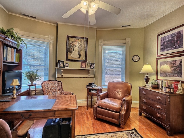 office space with light hardwood / wood-style flooring, ceiling fan, and crown molding