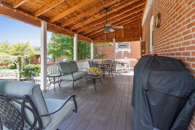 wooden deck with area for grilling and ceiling fan