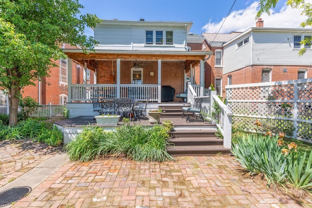 rear view of property with a patio and covered porch