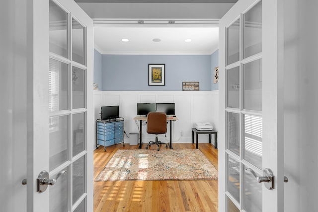 office space with hardwood / wood-style floors, french doors, and crown molding