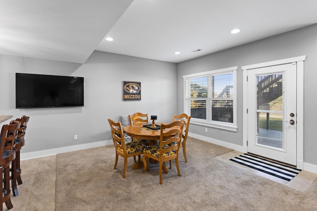 dining space with light carpet