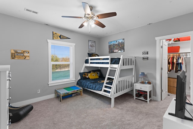 bedroom with a closet, ceiling fan, and carpet flooring