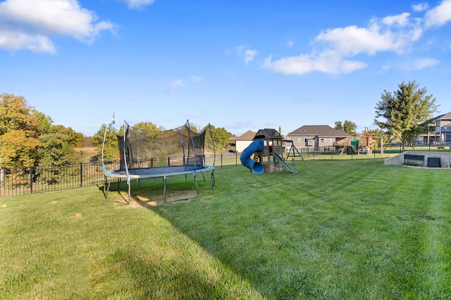 view of yard featuring a trampoline and a playground