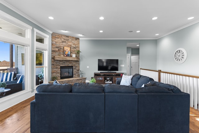 living room with crown molding, a fireplace, and light hardwood / wood-style floors