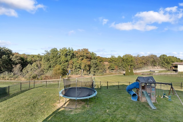 view of yard featuring a trampoline and a playground