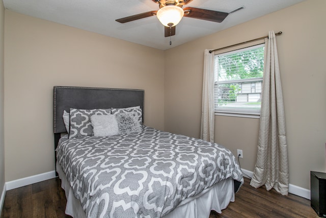 bedroom with ceiling fan and dark hardwood / wood-style floors