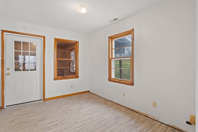 unfurnished room with light hardwood / wood-style flooring