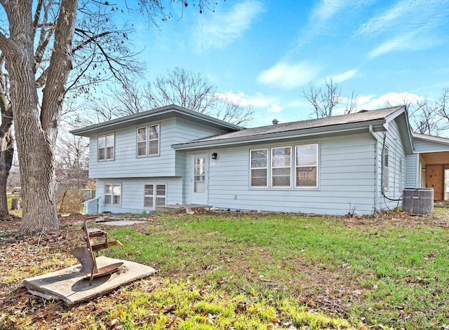 split level home with a front lawn and central AC unit