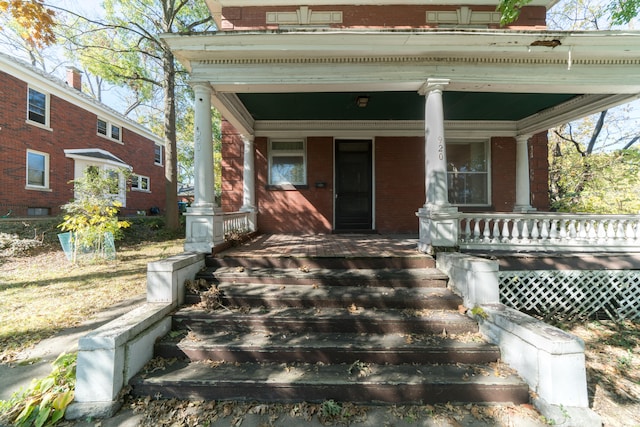 view of exterior entry with covered porch