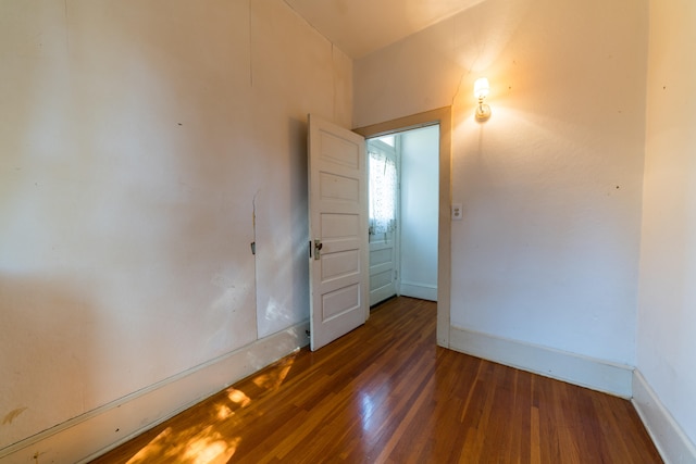 empty room featuring dark wood-type flooring