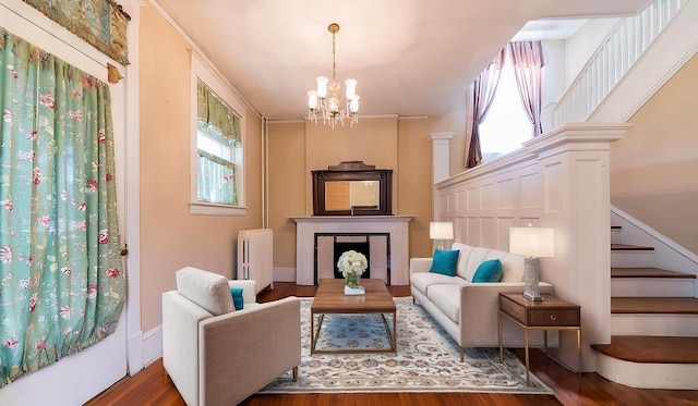 sitting room featuring a chandelier, ornamental molding, dark hardwood / wood-style floors, and radiator