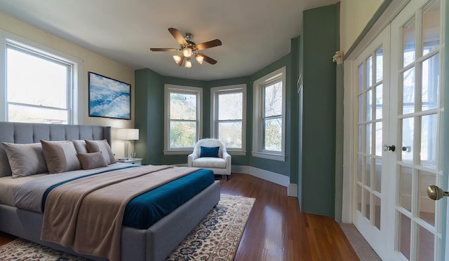 bedroom with dark wood-type flooring, ceiling fan, and french doors