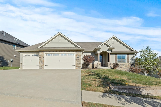 craftsman house with a garage and a front lawn