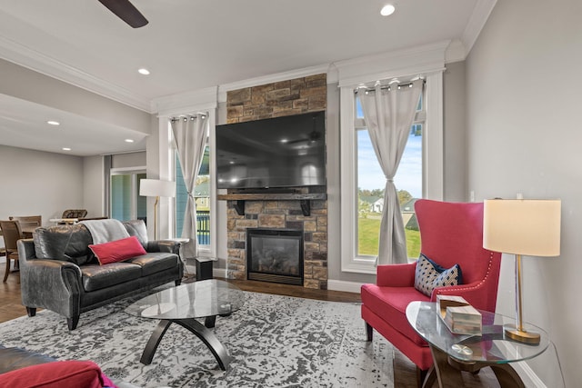 living room with ornamental molding, wood-type flooring, and plenty of natural light