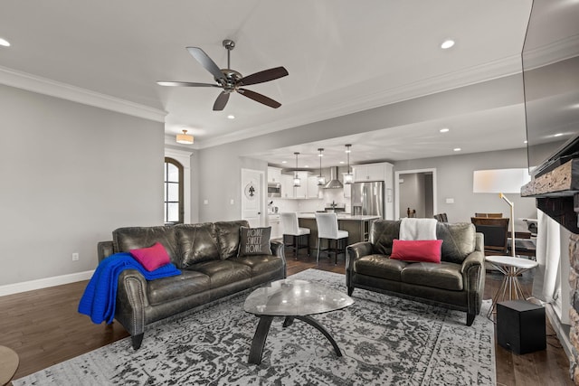 living room with ornamental molding, dark hardwood / wood-style floors, and ceiling fan